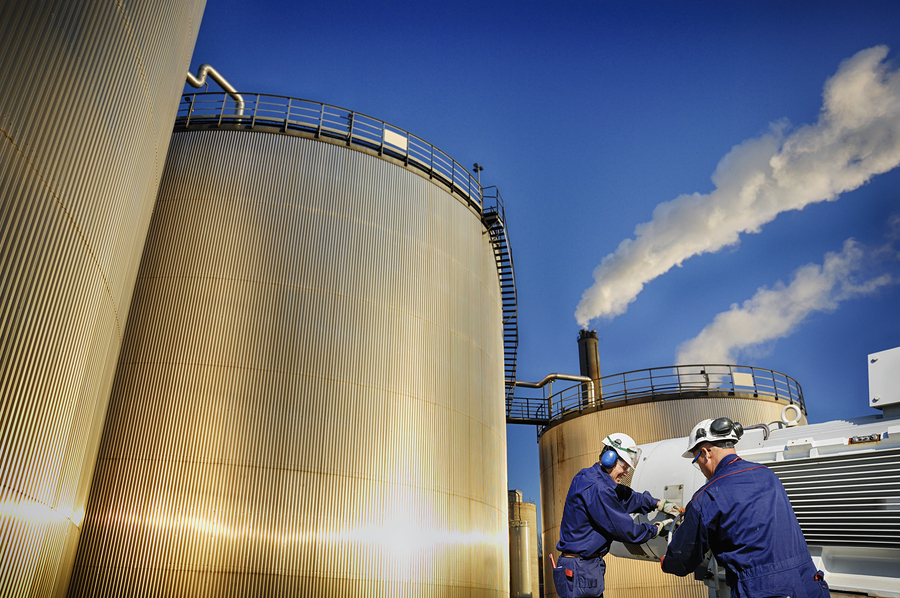 oil workers cleaning storage tanks